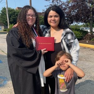 Tabetha Smith at her daughter’s high school graduation, standing with family and celebrating this milestone together.
