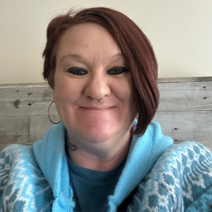 Tabetha Smith smiling in a blue sweater, representing her fresh start after prison through fair chance employment.