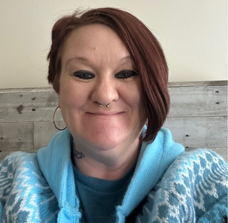 Tabetha Smith smiling in a blue sweater, representing her fresh start after prison through fair chance employment.