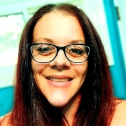 Erin Hoover smiling in her home workspace.